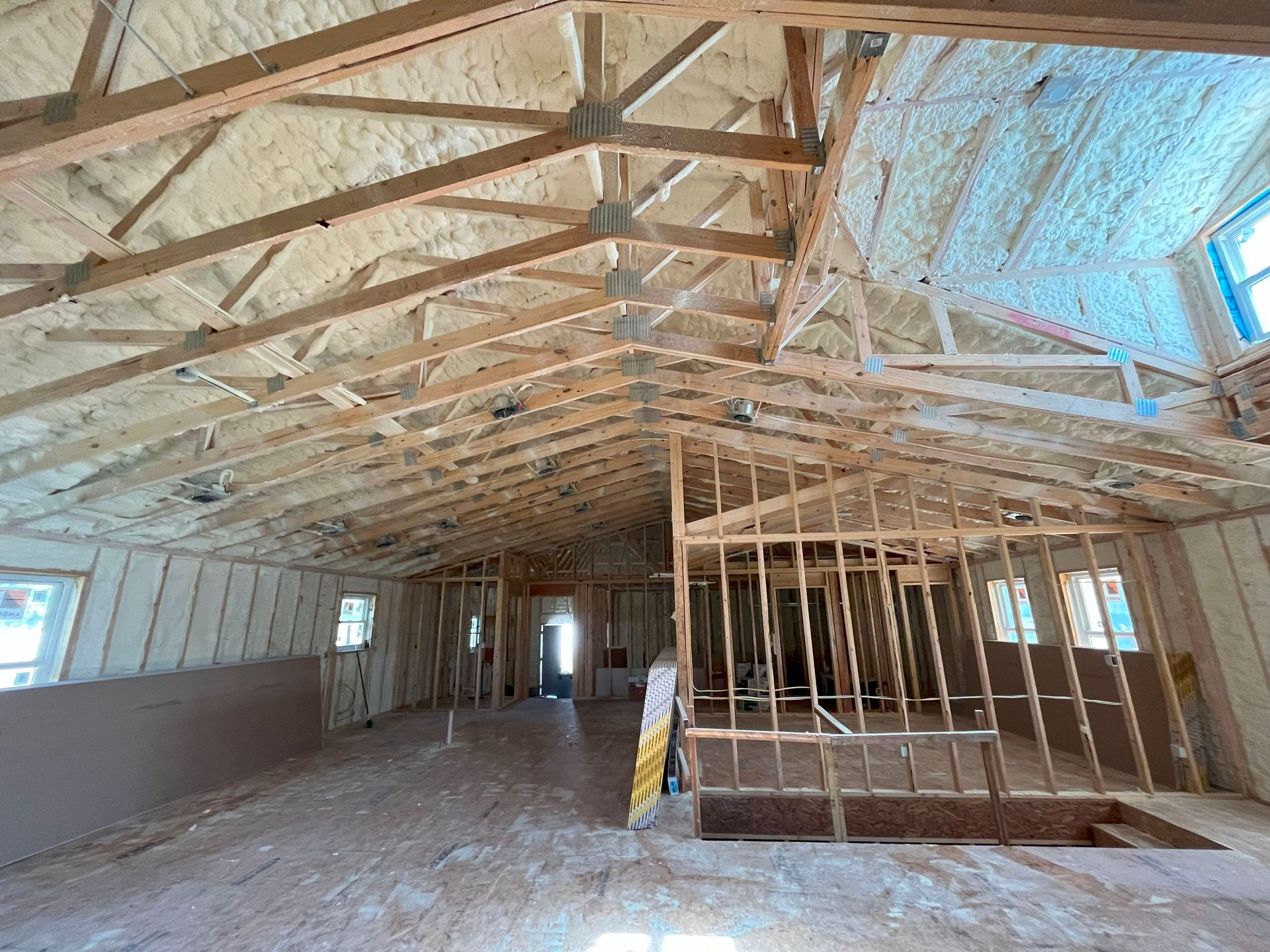 A large room with a ceiling that is being built.