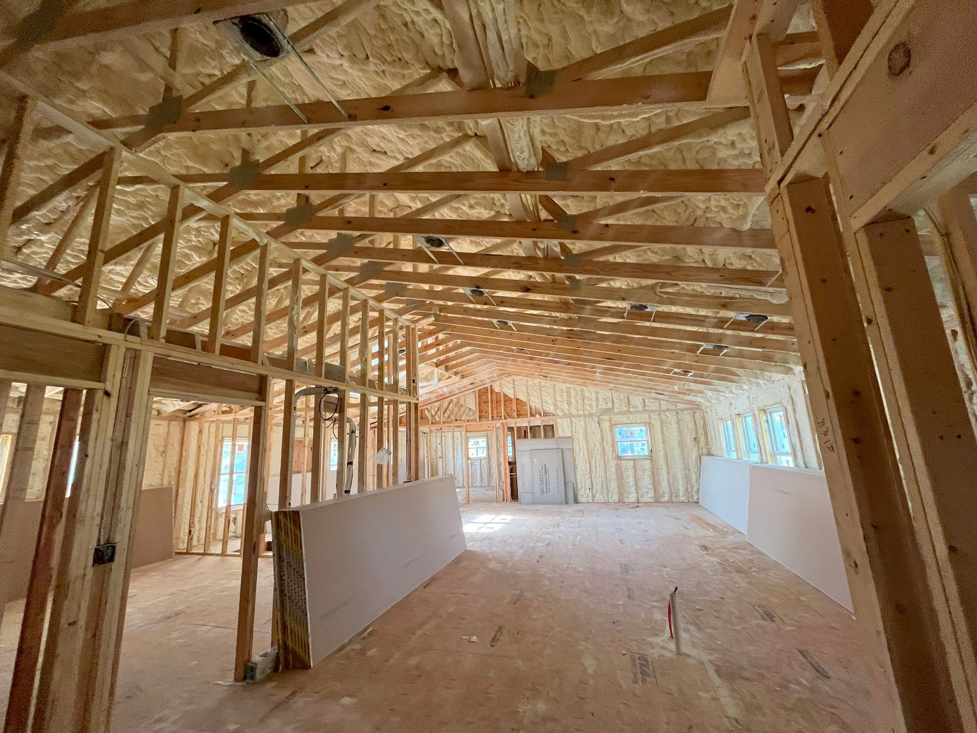 The inside of a building under construction with wooden beams.