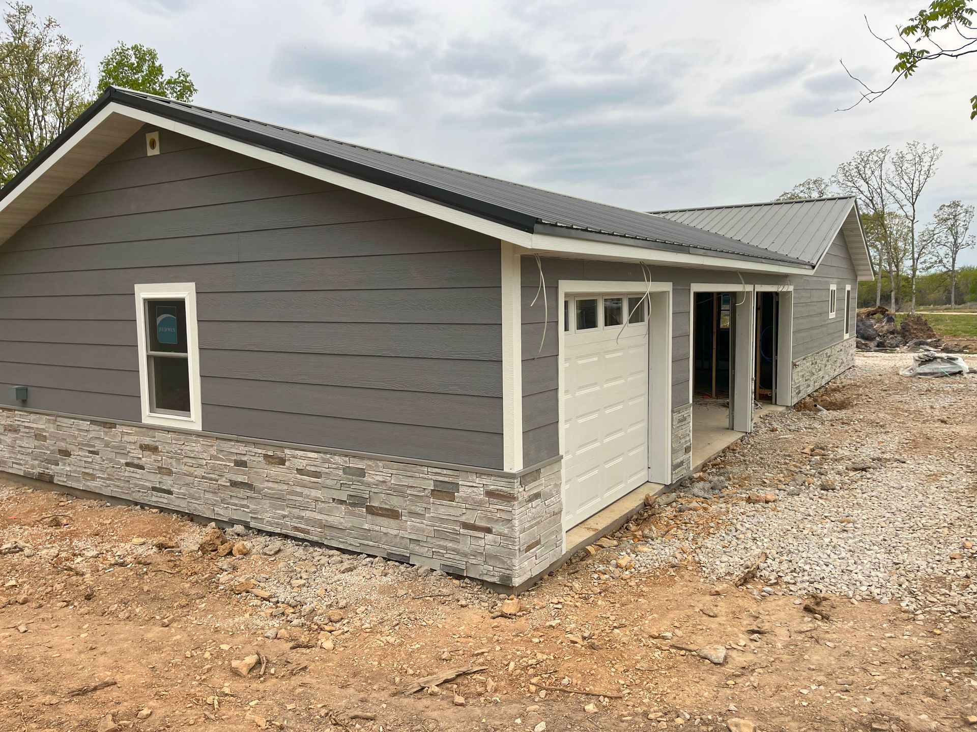A house with a garage underneath it is being built.