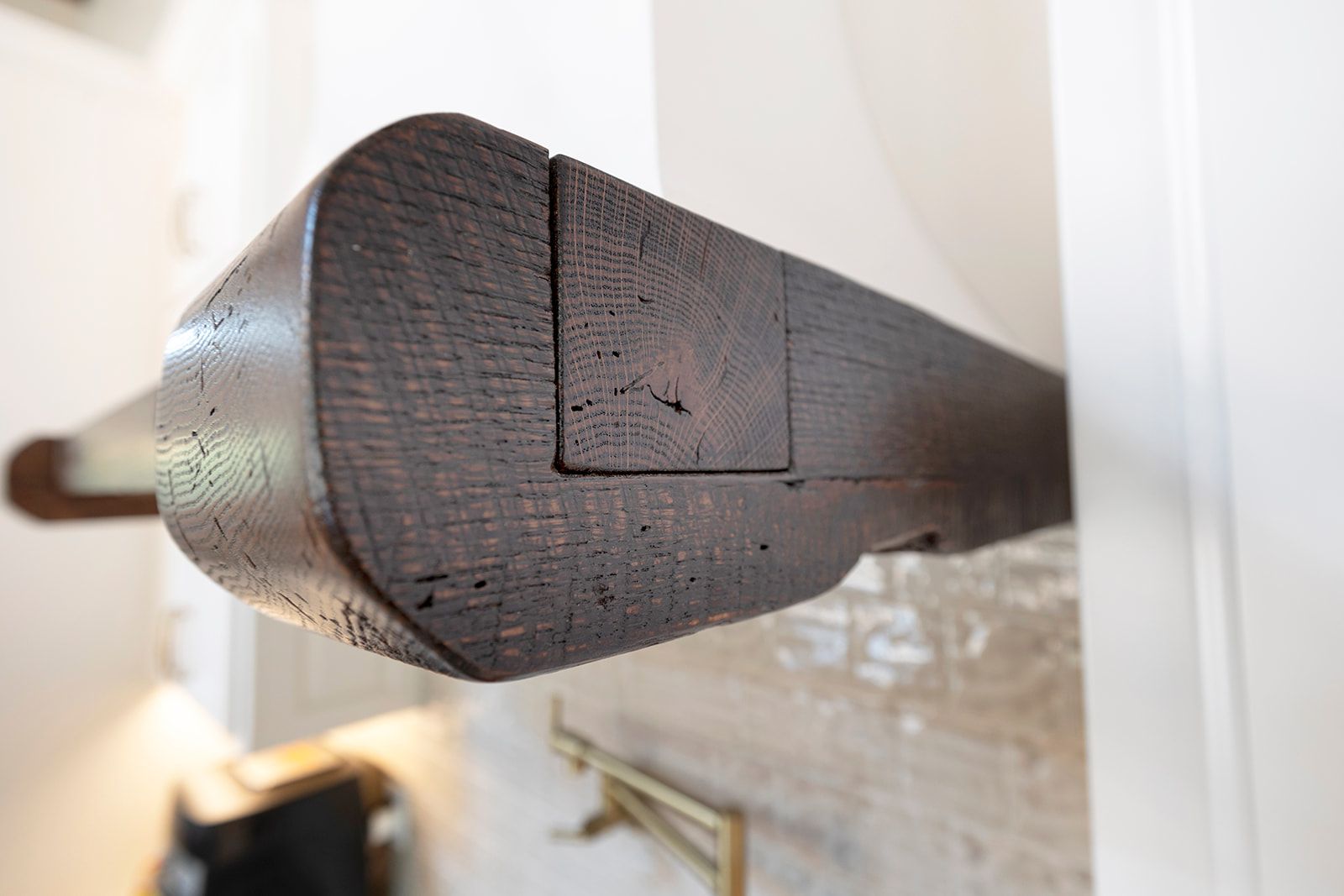 A close up of a wooden railing in a room.
