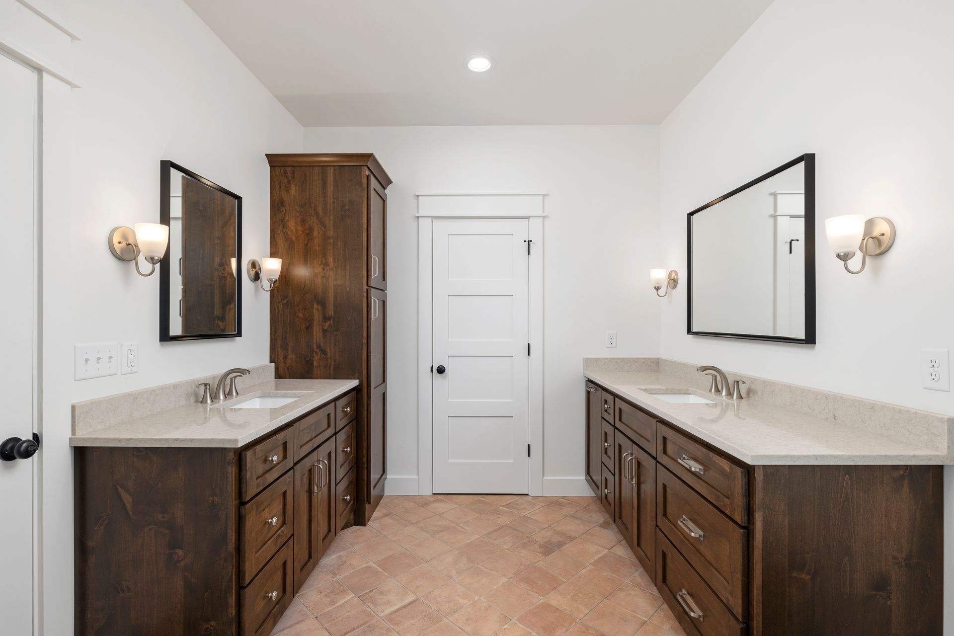A bathroom with two sinks and two mirrors.