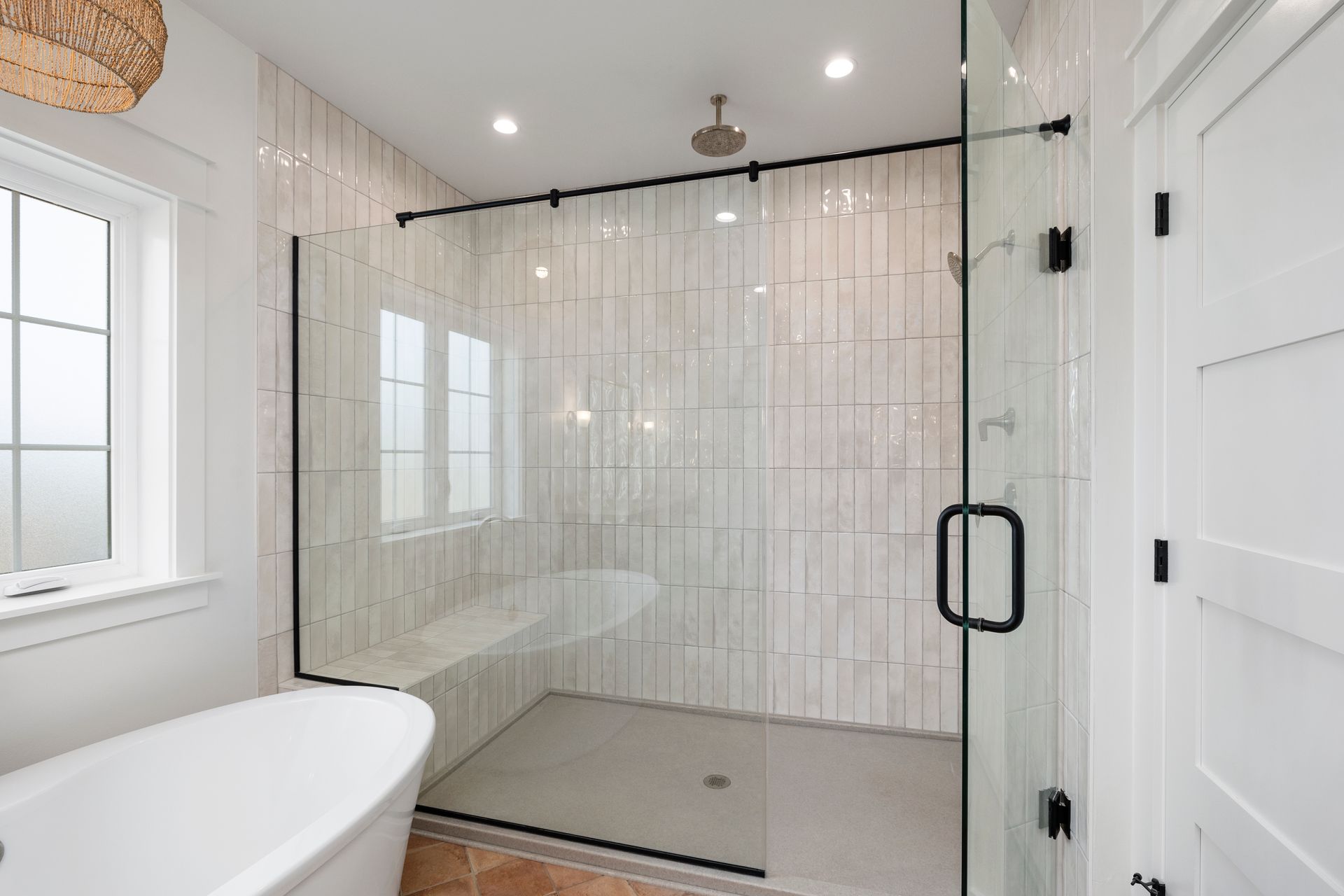 A bathroom with a walk in shower and a bathtub.
