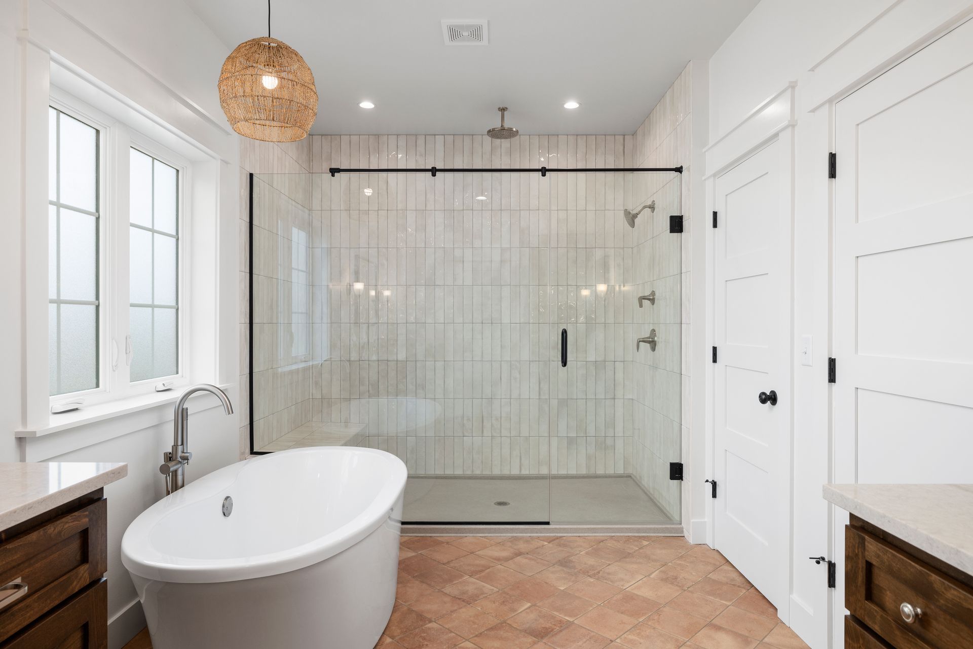 A bathroom with a bathtub and a walk in shower.