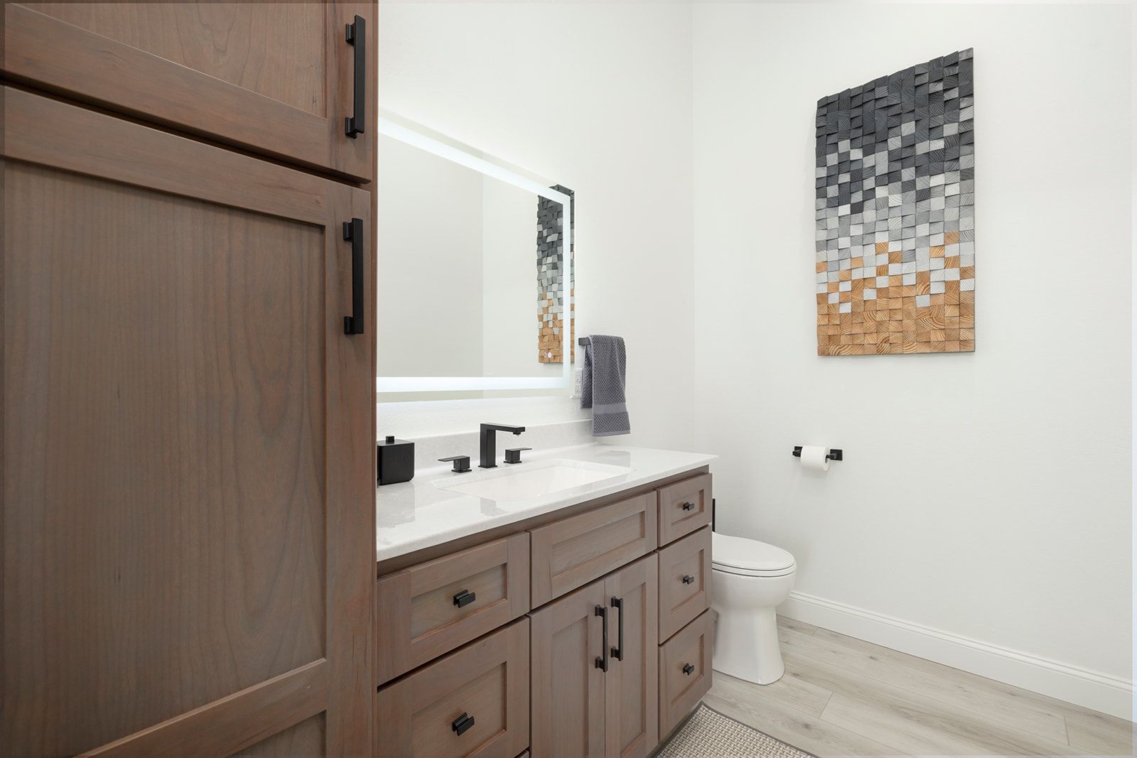 A bathroom with a sink , toilet and mirror.