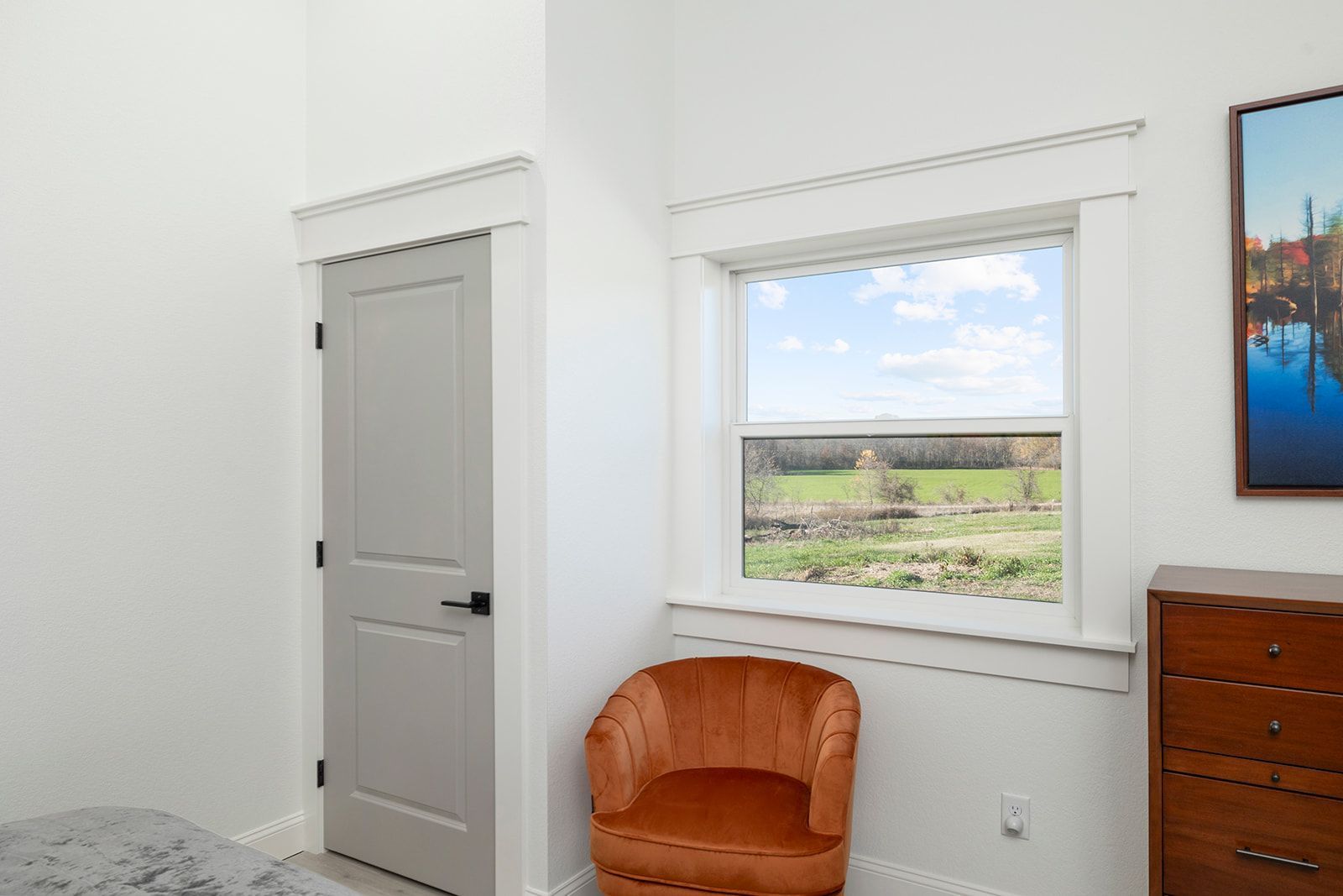 A chair is sitting in a room next to a window.