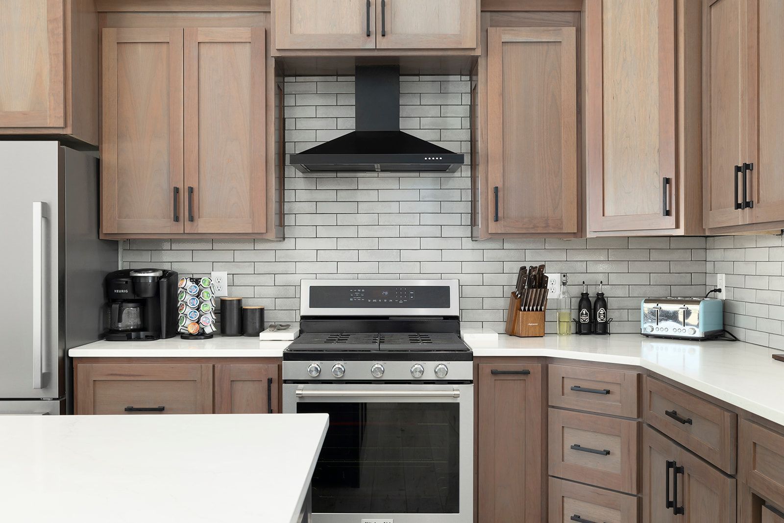 A kitchen with stainless steel appliances and wooden cabinets.