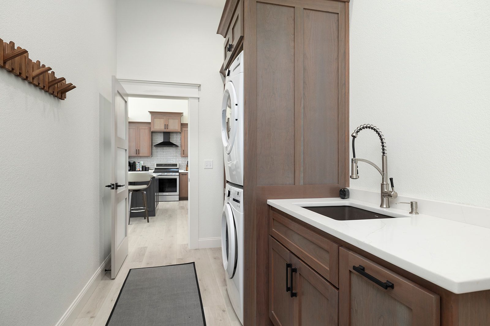 A laundry room with a washer and dryer and a sink