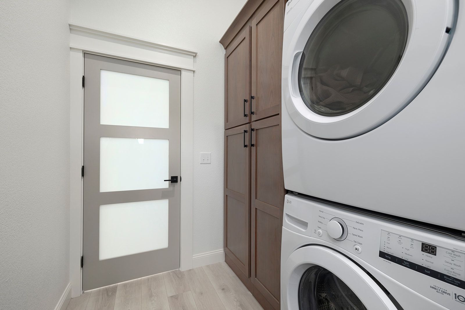 A laundry room with a washer and dryer stacked on top of each other.