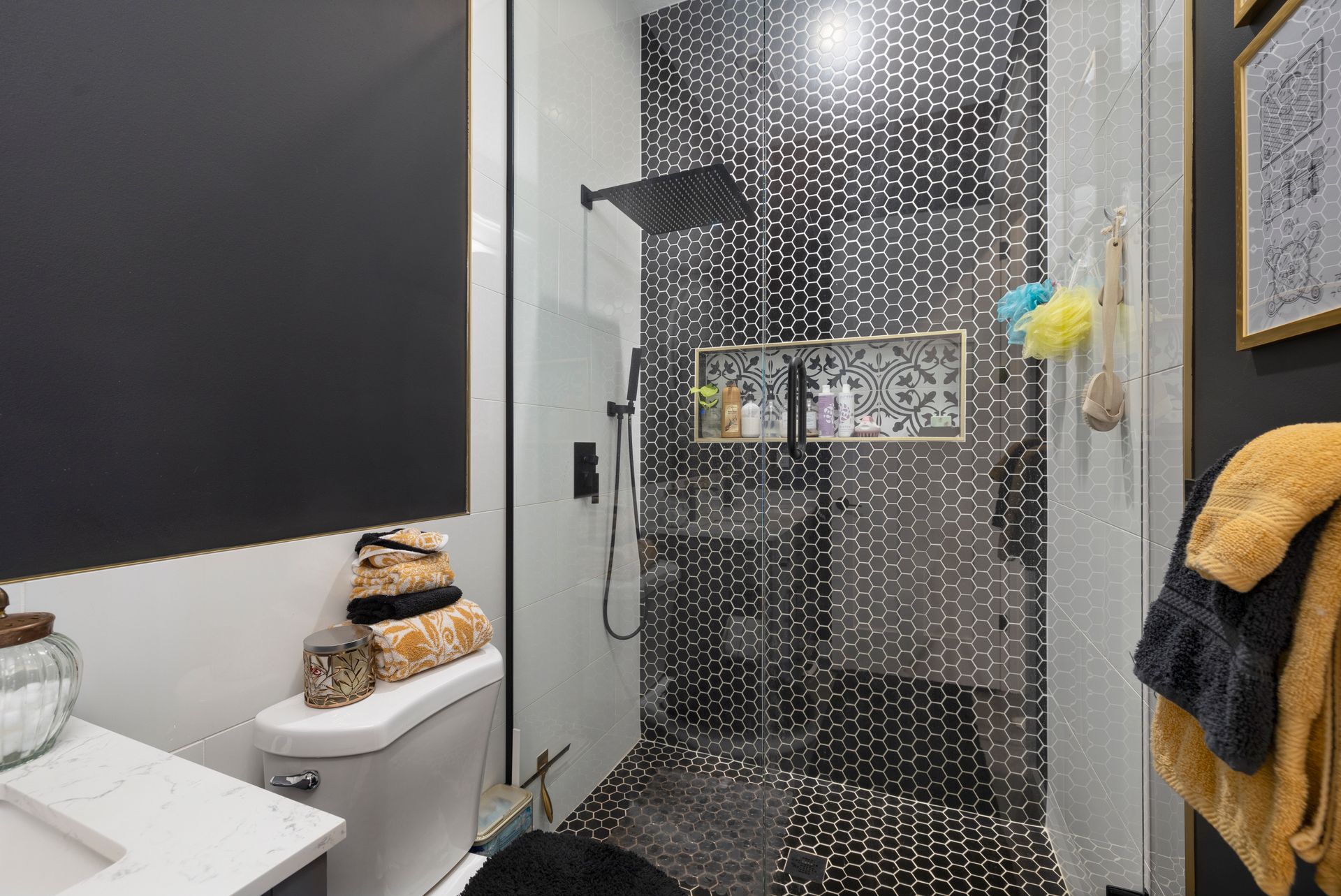 A bathroom with a toilet , sink , and walk in shower.