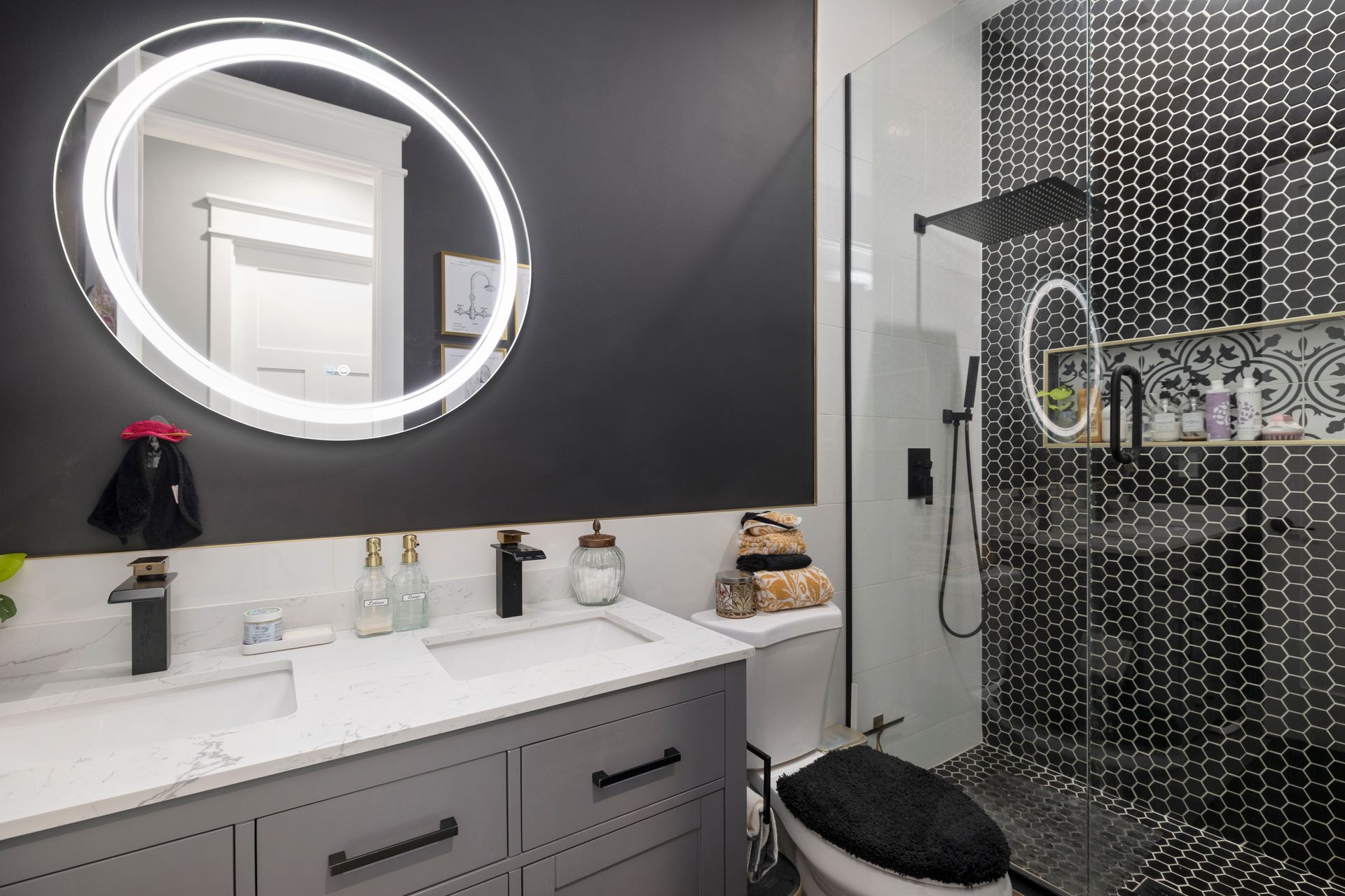 A bathroom with a sink , toilet , shower and mirror.