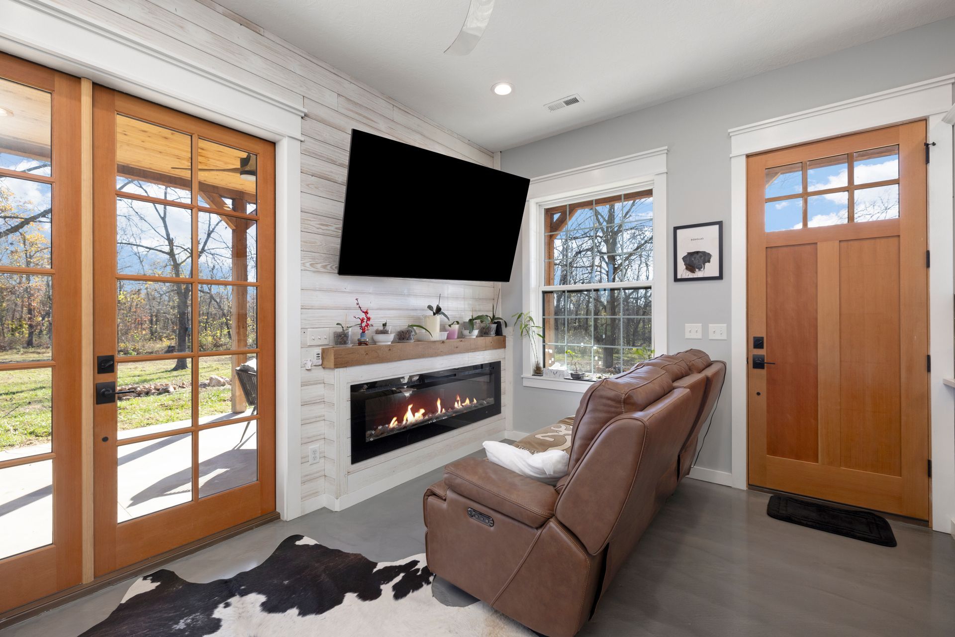 A living room with a fireplace and a flat screen tv.