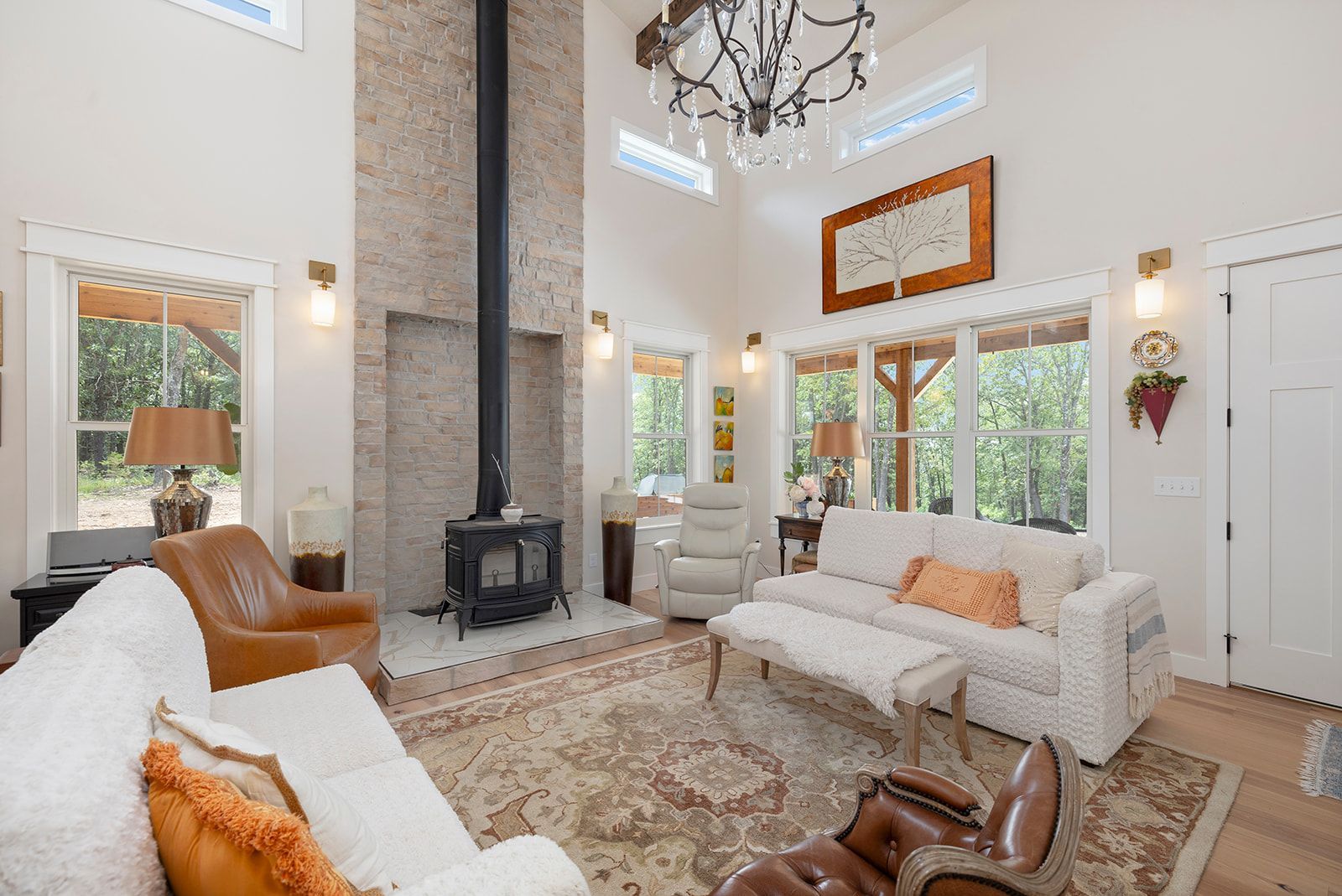 A living room with a couch , chairs , and a fireplace.