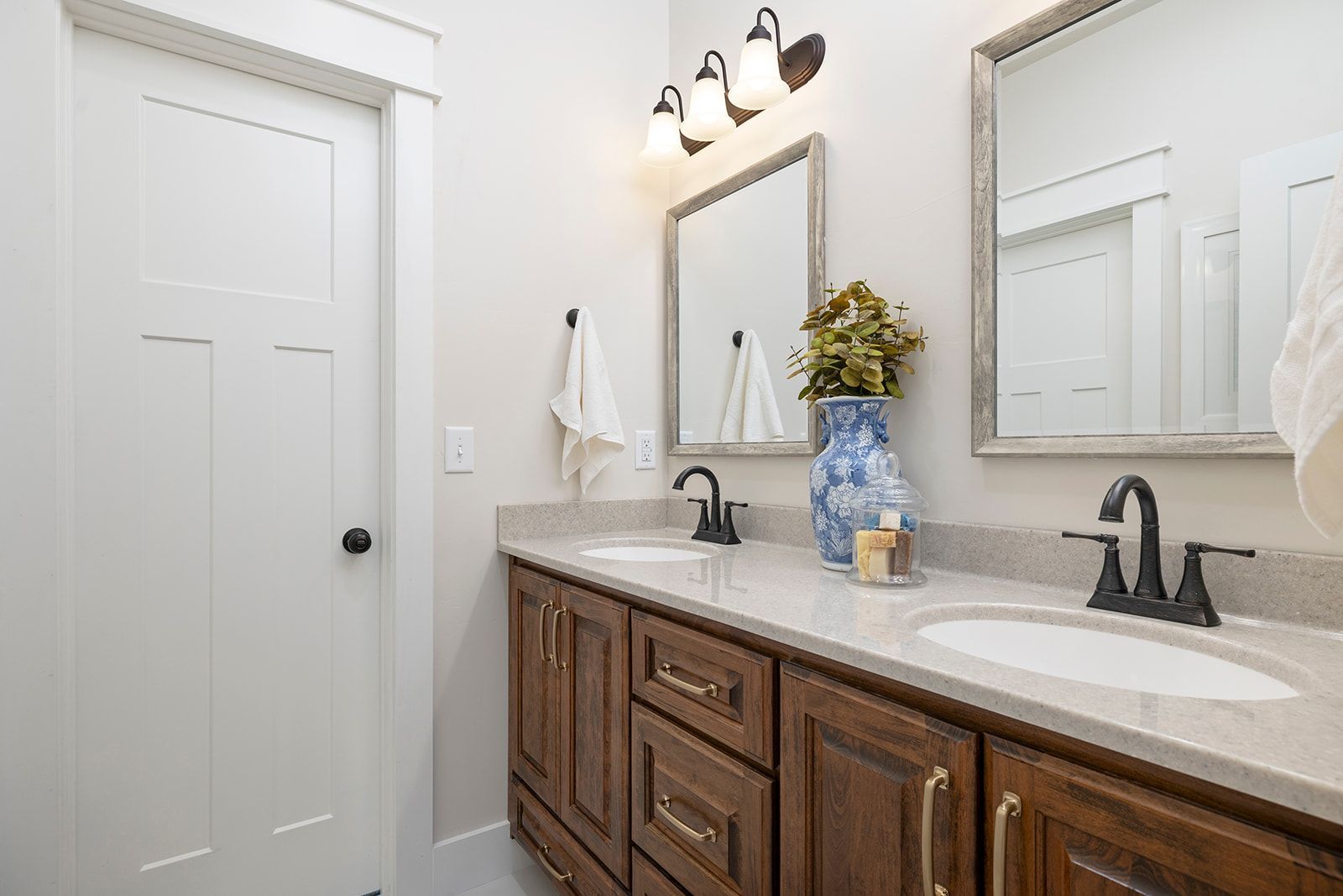 A bathroom with two sinks and two mirrors.