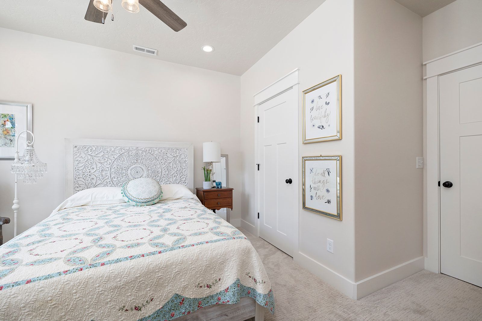 A bedroom with a bed and a ceiling fan.