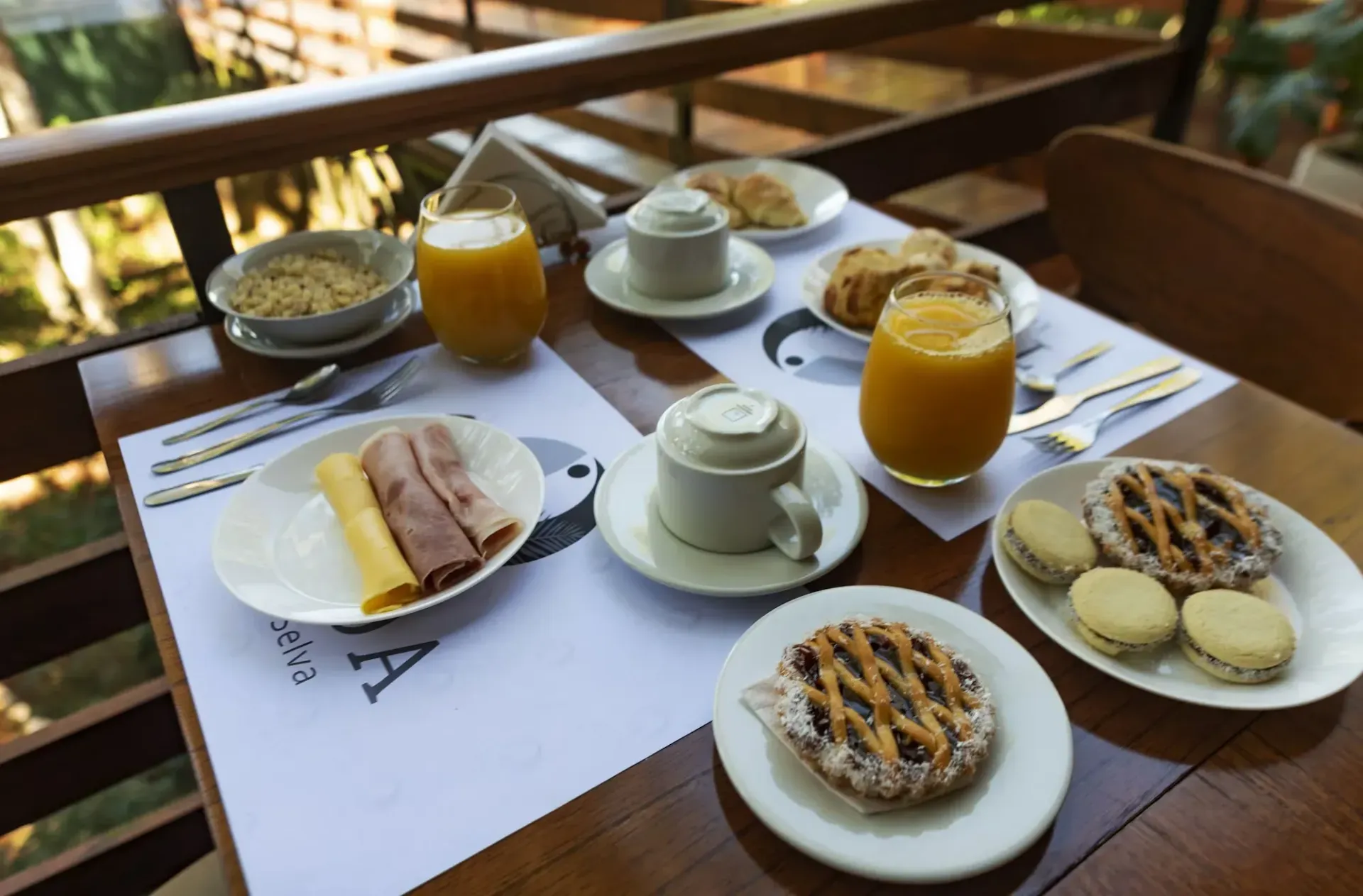 A table topped with plates of food and drinks.