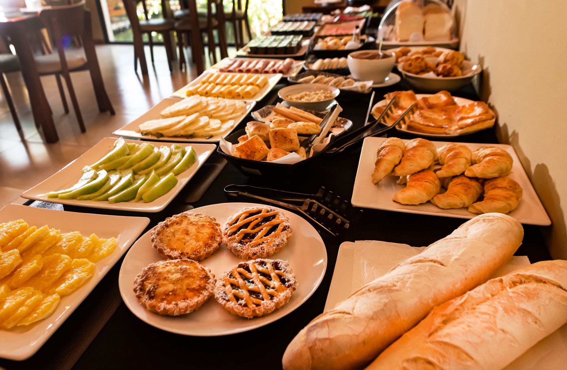 A table filled with a variety of food including bread and fruit