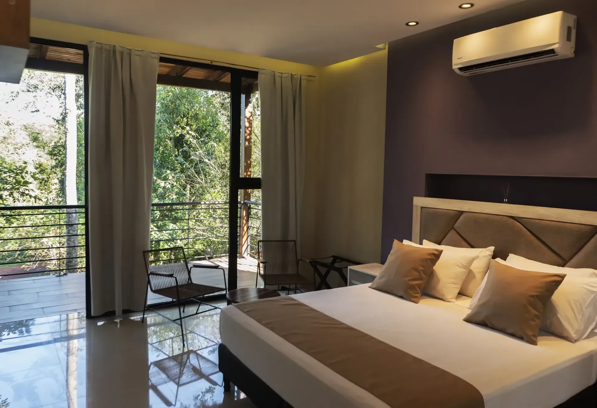 A hotel room with a large bed and a balcony