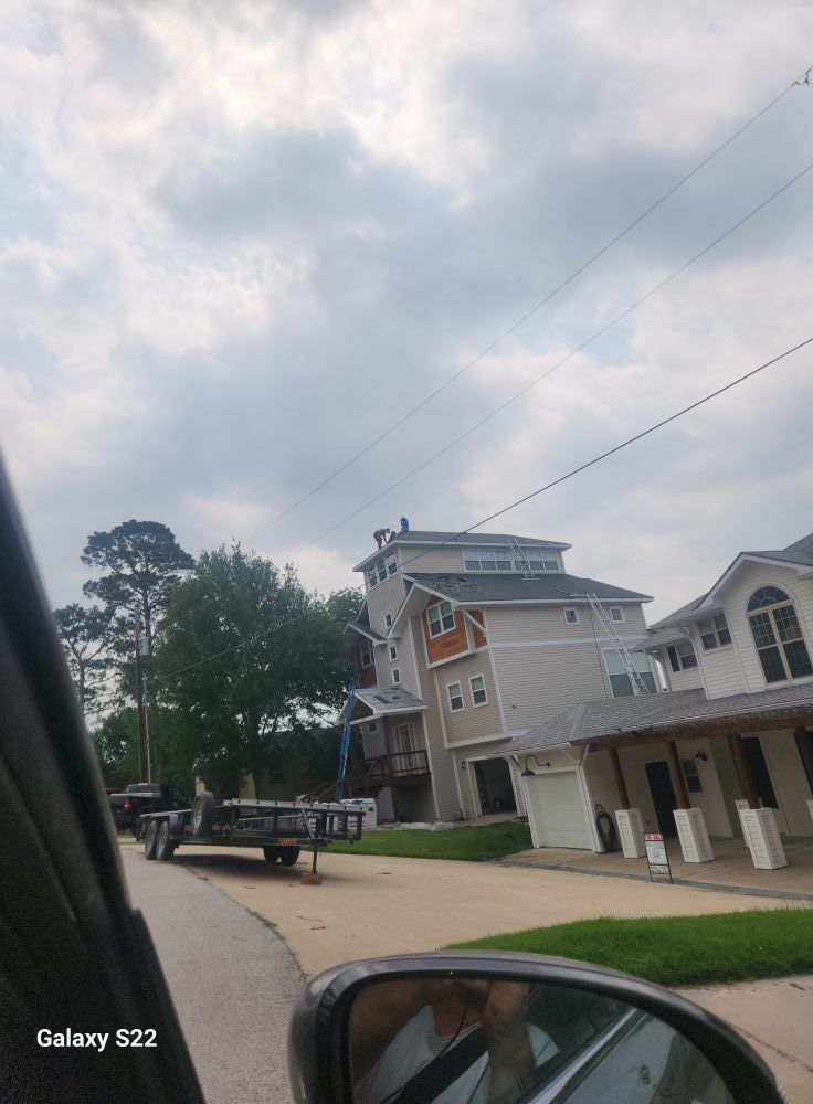 Quiet street with a white building, parked trailer, and cloudy sky