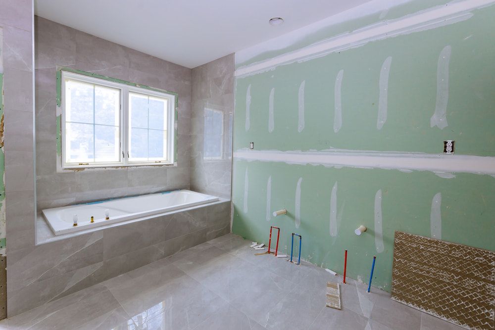 Bathroom With a Sink , Mirror , Tub and Shower — Shaun Jarvis Quality Construction in Newcastle, NSW