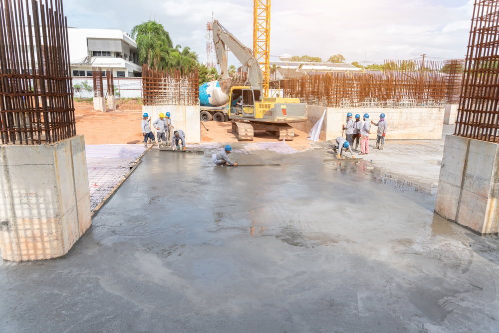 Group of Construction Workers Are Working on a Concrete Floor at a Construction Site — Shaun Jarvis Quality Construction in Lake Macquarie, NSW