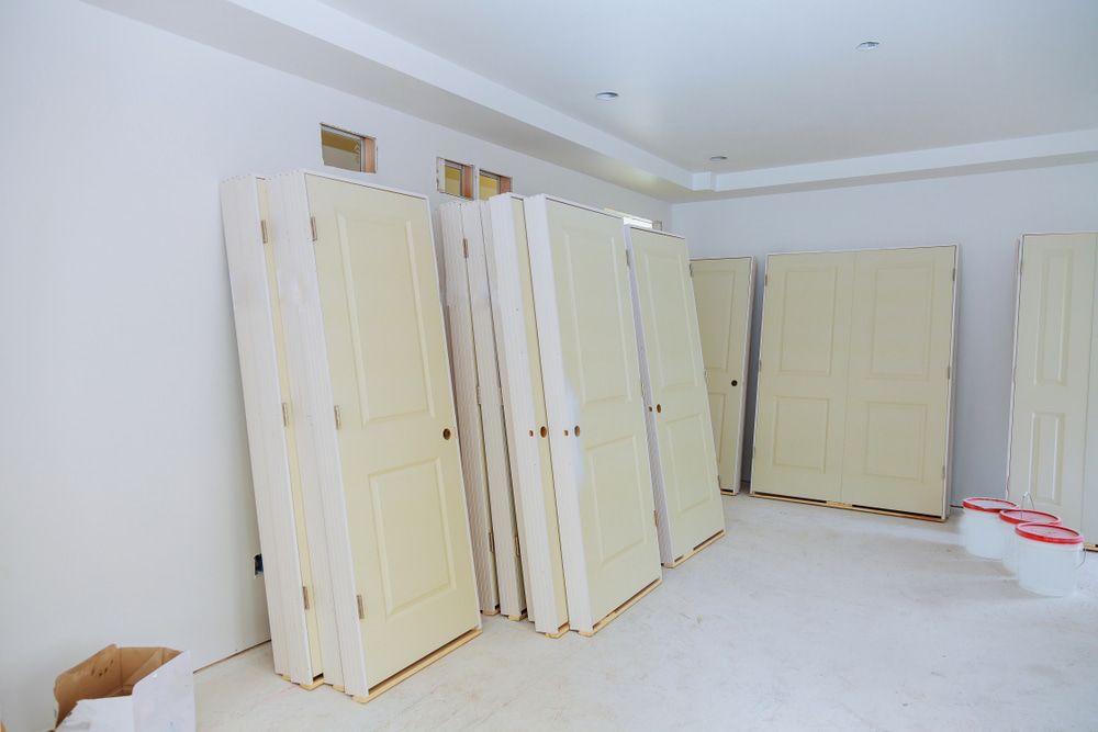 Room With a Lot of White Doors Stacked on Top of Each Other — Shaun Jarvis Quality Construction in Nelson Bay