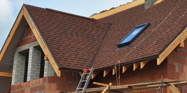 A house is being built with a skylight on the roof.