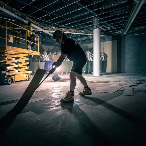 A Construction Worker Used A Power Concrete Grinder — Demolition Services In Mackay, QLD