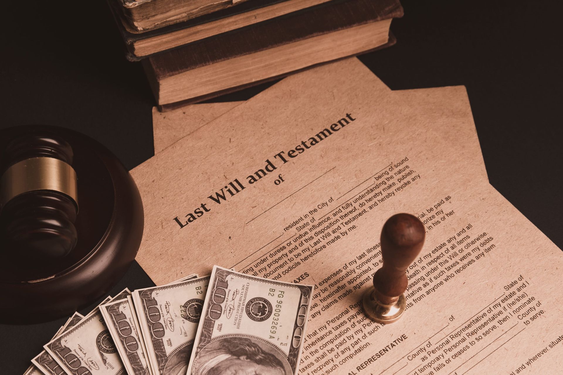 Last will and testament document with money, gavel, and stack of books on a desk