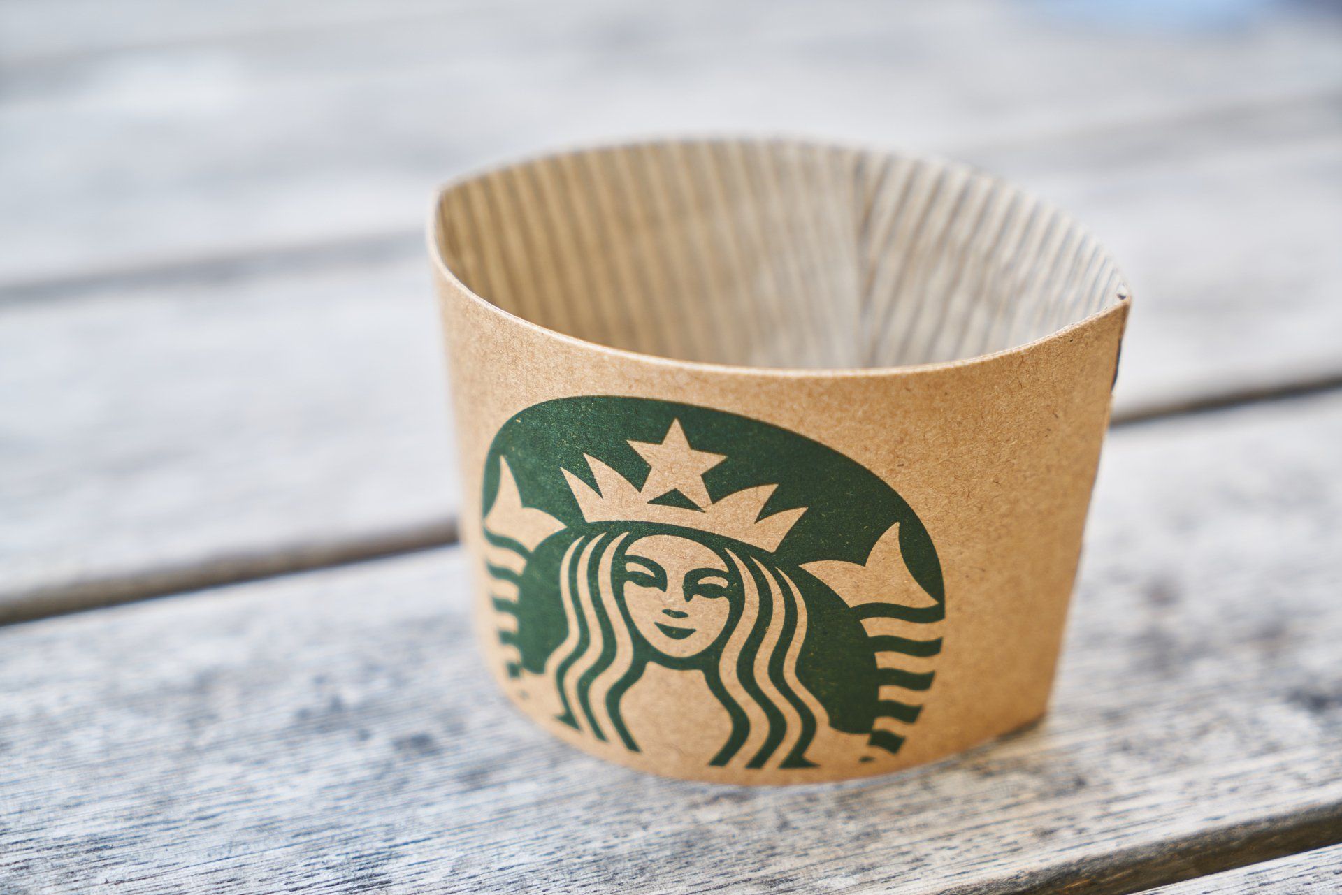 Starbucks coffee sleeve on a wooden table