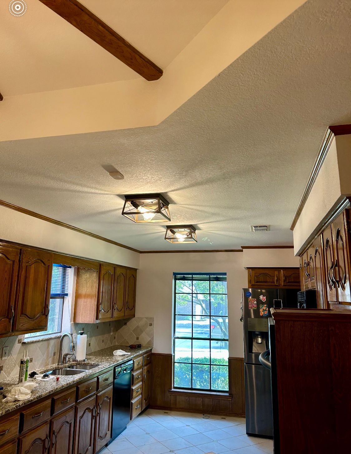 A kitchen with stainless steel appliances and wooden cabinets