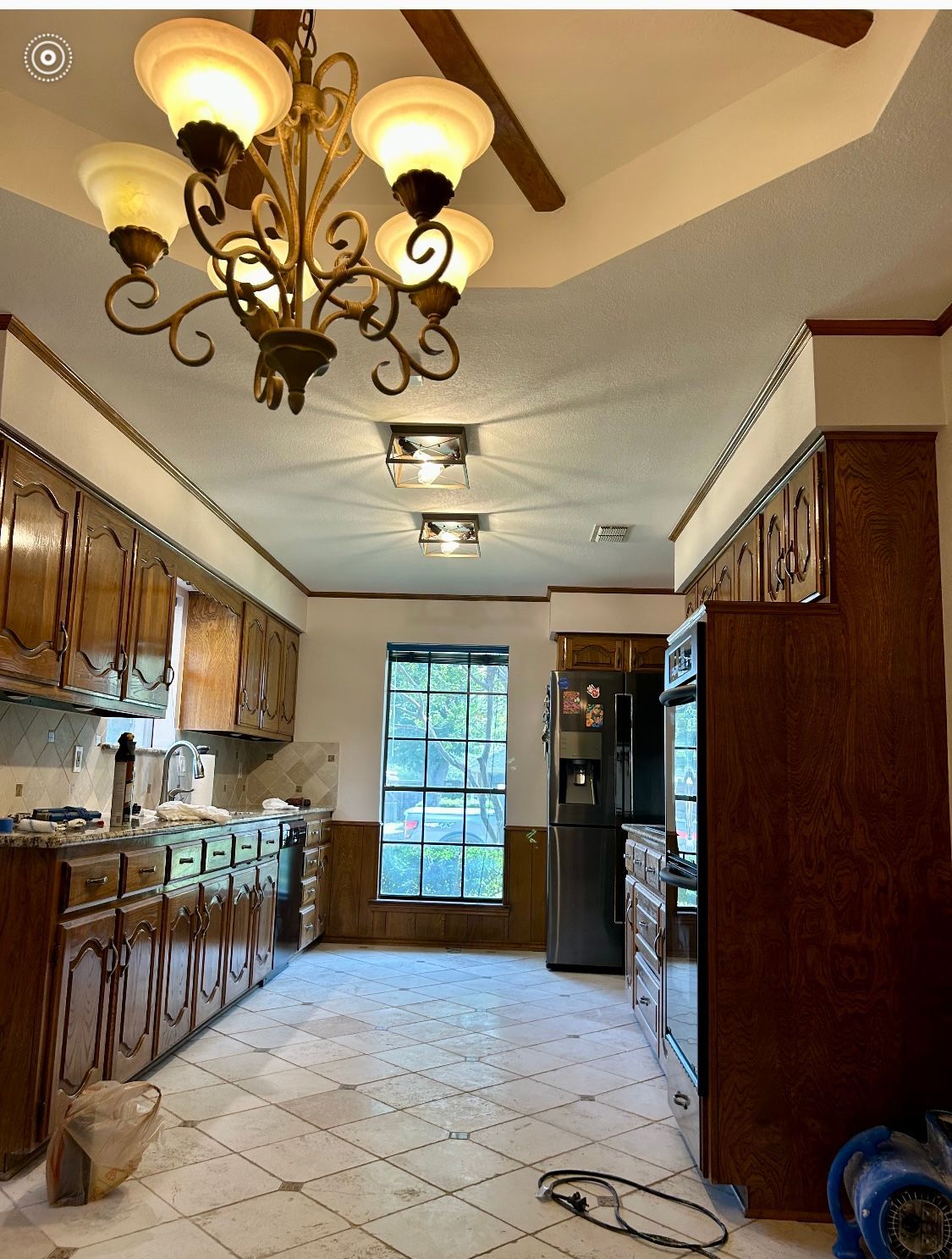 A kitchen with a chandelier hanging from the ceiling