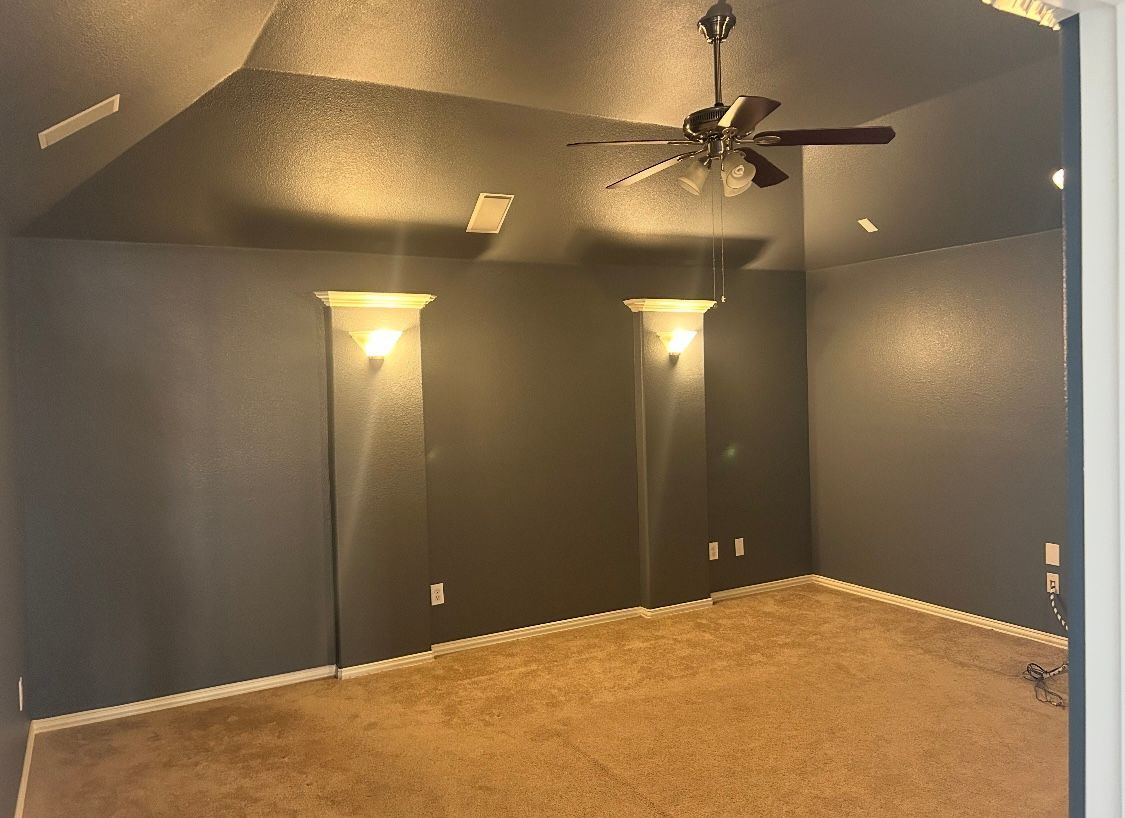 There is a ceiling fan in the corner of the room.