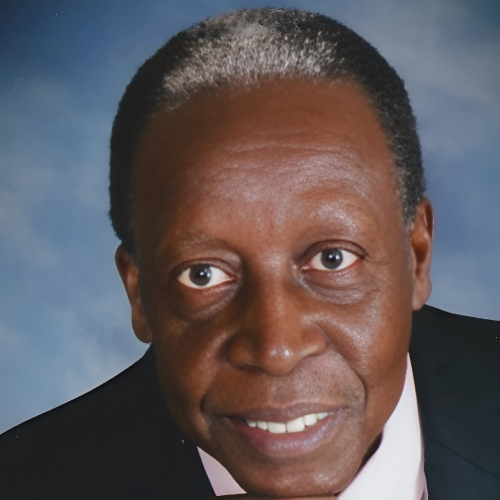 A man in a suit and tie smiles for the camera