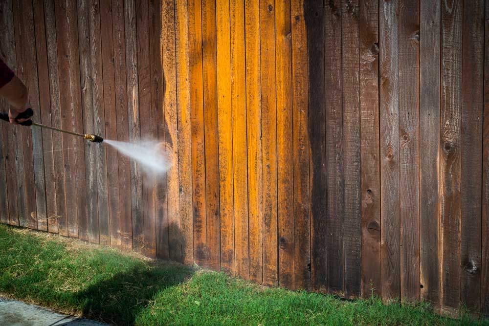 A Fence Being Power Washed — Pressure Cleaning in Nambucca Valley, NSW