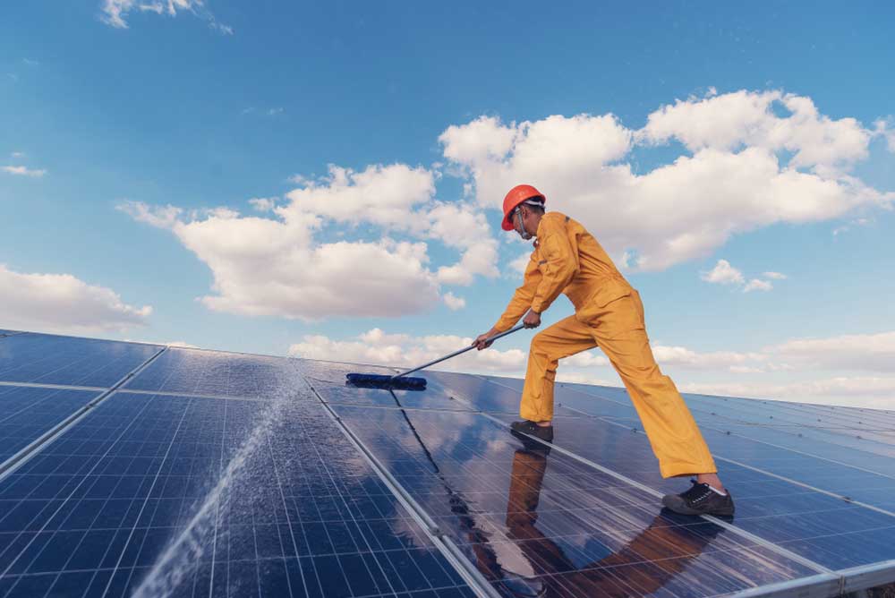 A Solar Panel Being Scrubbed Clean — Pressure Cleaning in Nambucca Valley, NSW