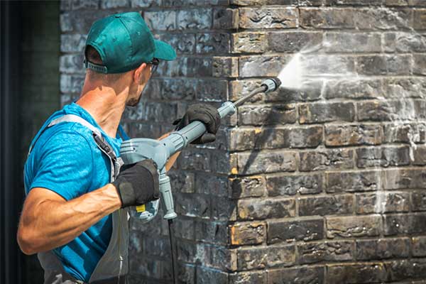 A Brick Wall Being Pressure Cleaned — Pressure Cleaning in Nambucca Valley, NSW