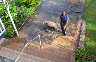 A Man Power Washing A Patio — Pressure Cleaning in Nambucca Valley, NSW