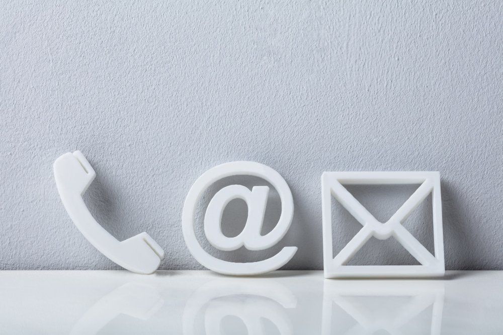 Phone, Email And Post Icons Leaning On White Wall — Pressure Cleaning in Nambucca Valley, NSW