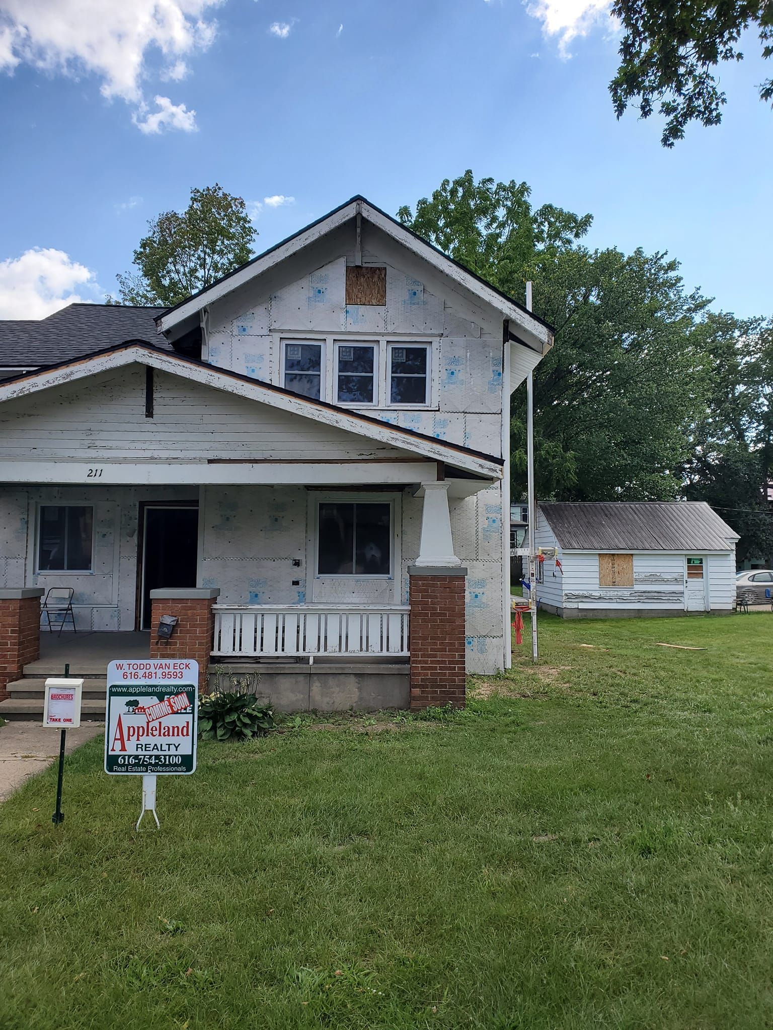 White two-story house with porch and 