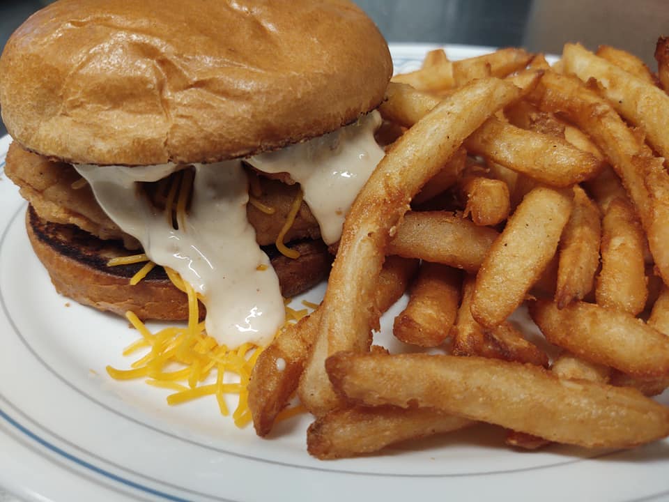 burger with white sauce and french fries