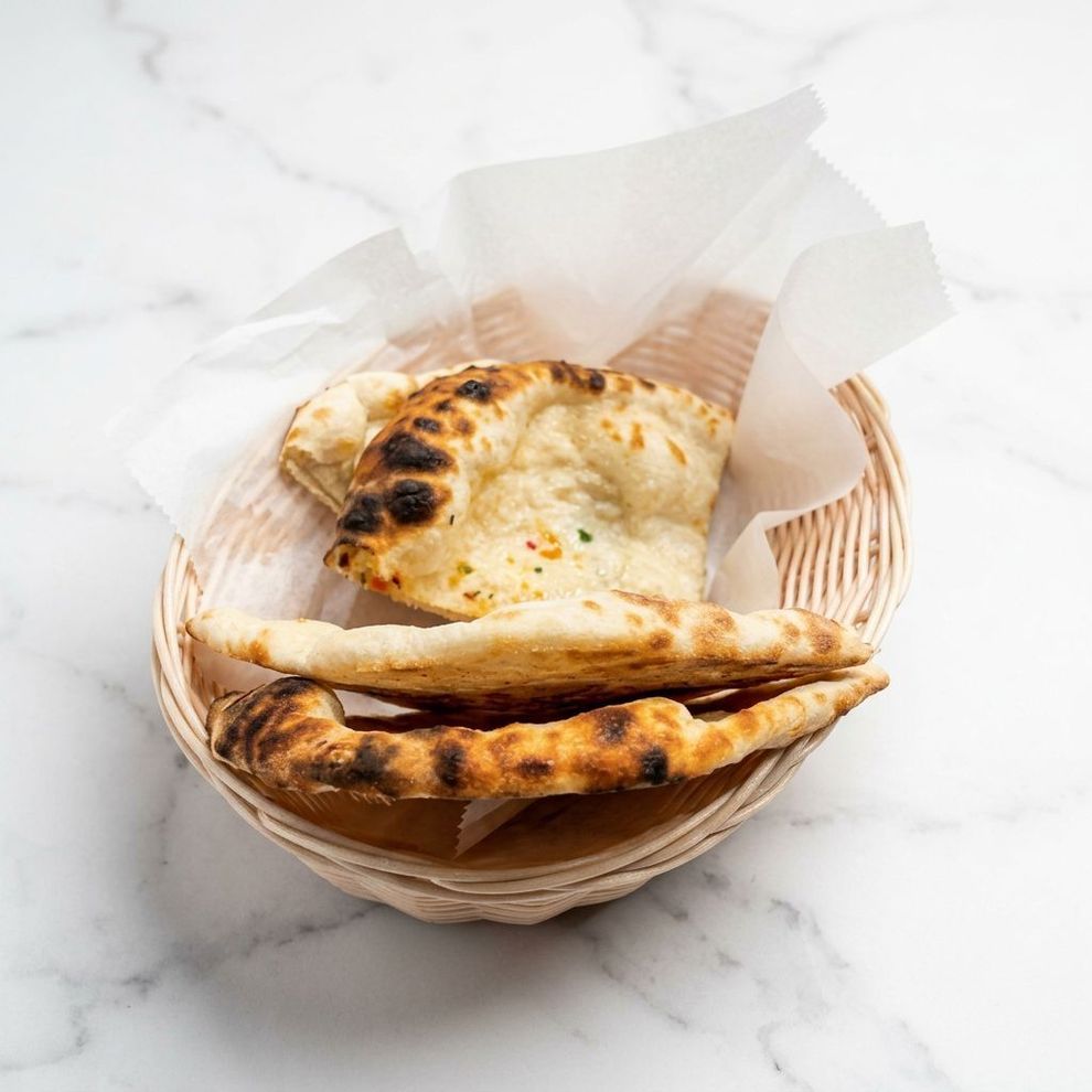 Dahi puri: Deep-fried, puffed bread balls filled with yogurt, chutneys, and savory toppings, served on a plate.