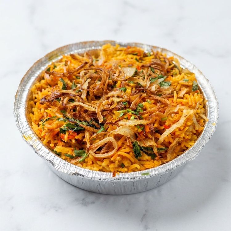 Close-up of a kachori chaat, topped with sev, pomegranate, chutney, and yogurt in a plastic bowl.