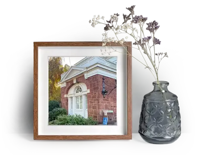 Vincent Funeral Home's exterior showing a window surrounded by plants