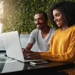 Young couple planning services on a laptop