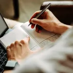 Close-up of person checking items off of a list