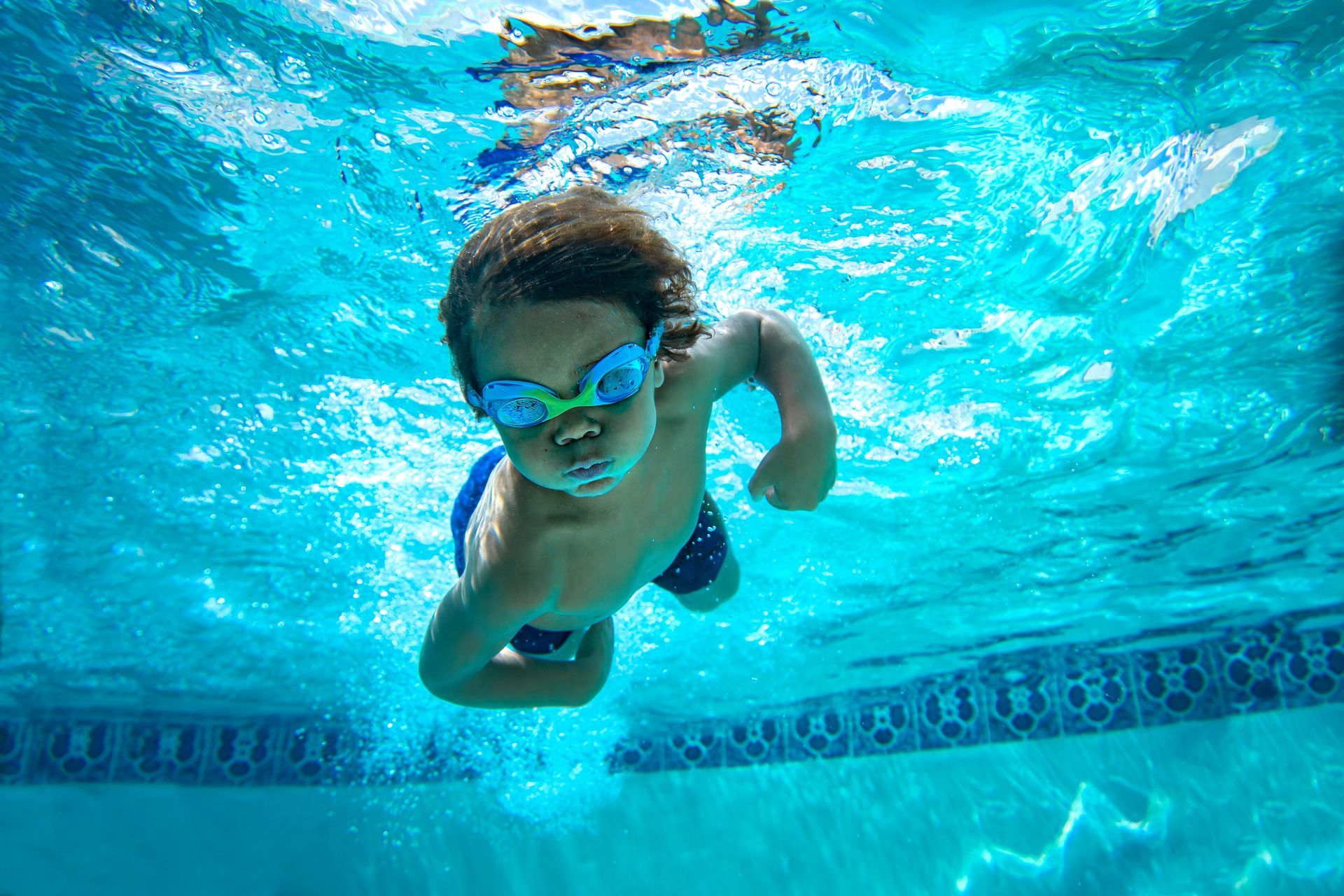 Toddler swimming underwater