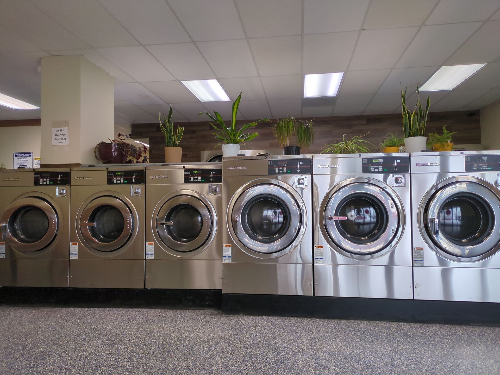 Row of washers showing three 30# and three 40# sized washers.  Stainless steel fronts.
