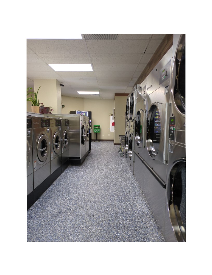 (2) Looking down main aisle with dryers and washers on either side. 