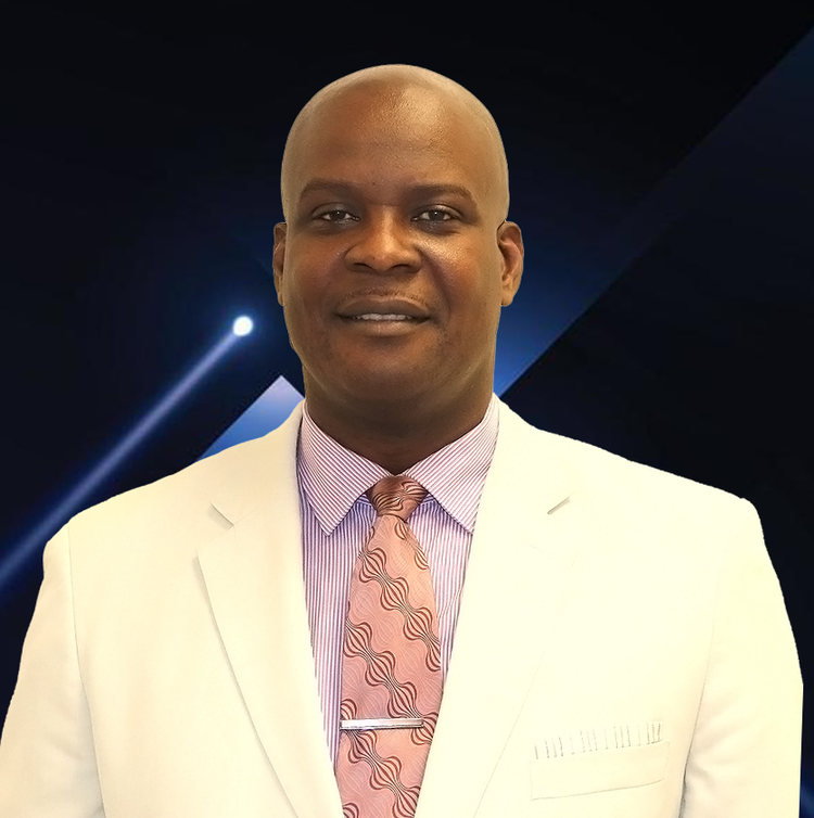 A man wearing a white suit and a pink tie