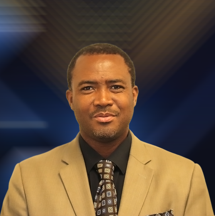 A man in a suit and tie looks at the camera